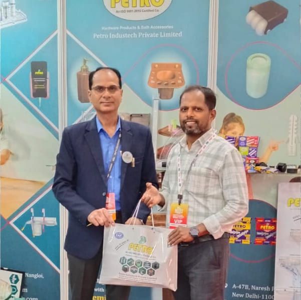 Petro Industech representative interacting with visitor and presenting product kit at trade exhibition booth