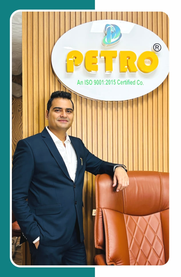 Nitesh Khurana standing in Petro office with company logo ISO 9001:2015 certified bathroom accessories manufacturer
